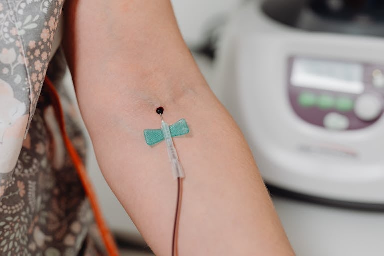 Detailed close-up image of blood being drawn using a needle, suitable for medical contexts.