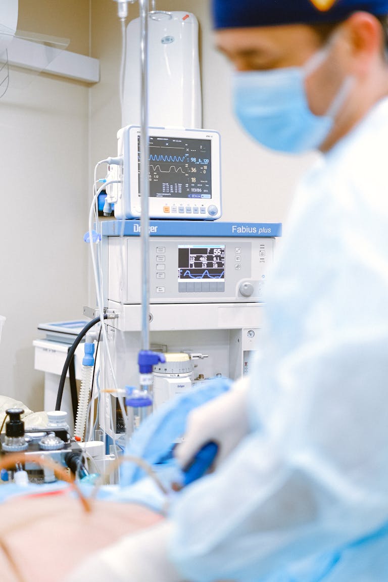 Doctor uses ECG monitor in hospital setting. Focus on healthcare and medical technology.